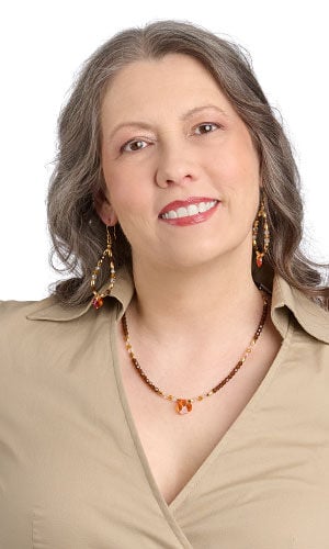 Model in tan top wearing design idea S A 2 9 a Beaded necklace and large teardrop-shaped earrings feature shades of topaz and clear crystal beads and sparkling topaz heart crystal pendants