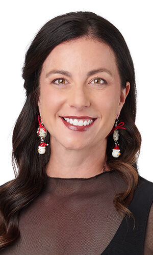 Design Idea P B 2 R - Woman wearing a black mesh top and festive snowman drop earrings topped with tiny red bows.