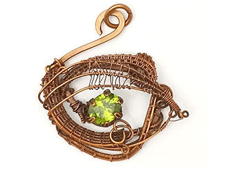 An image of a wire wrapped pendant with a peridot faceted gem