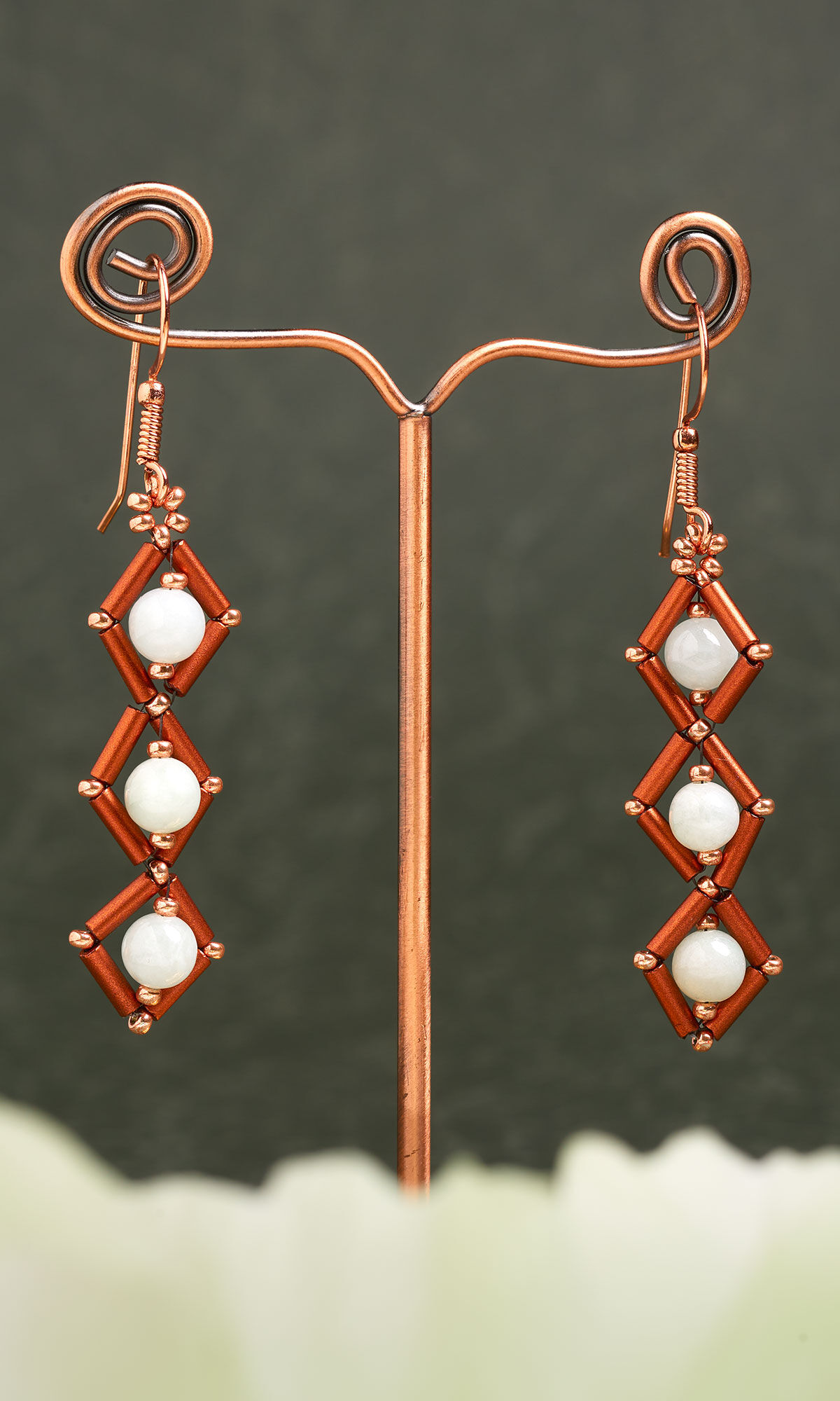 Design Idea R H 2 9 - earrings against a dark background with a misty foreground