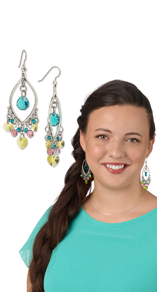 Model wearing earrings made with Crystal Passions beads and pendants