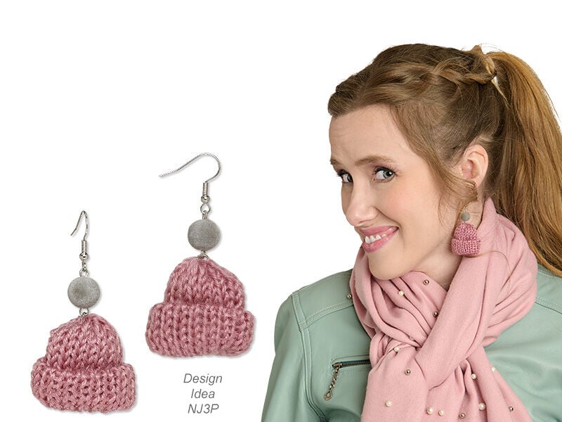 Model wearing earrings that look like tooks