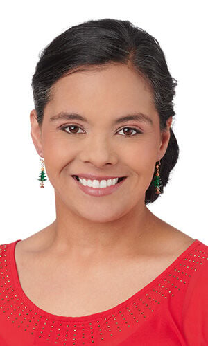 Design Idea P H 2 Z - A woman wearing a red scoop-neck top and green Christmas tree drop earrings.