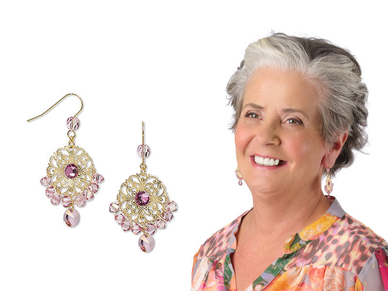 Model in blue wearing crystal dangled earrings