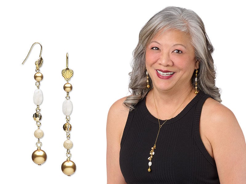 Model wearing a necklace and earrings made gemstone and crystal beads