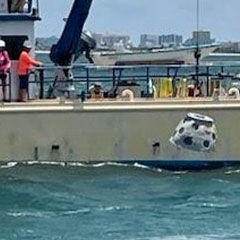 Frank's reef being lowered into the ocean with a crane