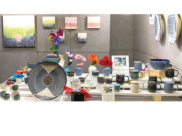 Booth displaying ceramic and paintings