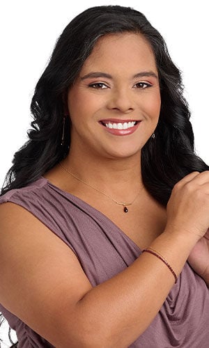 A model in a purple top wearing Design Idea R F 4 8