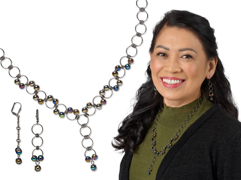 Model wearing a necklace and earrings that uses many jump rings