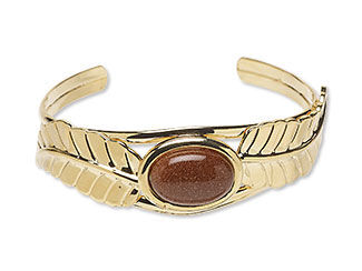 An image of a goldstone cabochon in a cuff bracelet setting