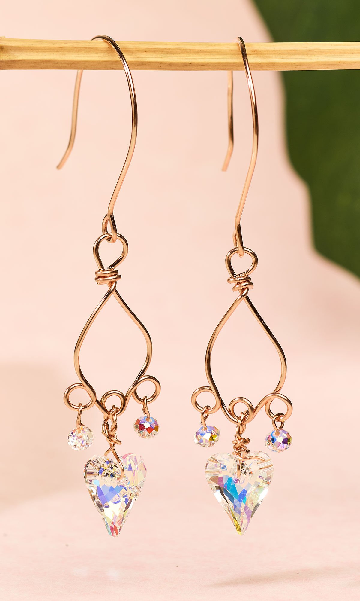 Design Idea Q M 3 7 hanging on a small gold bar over a pink cloth