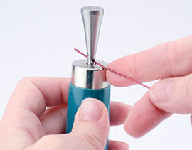 Inserting wire through the hole in the mandrel