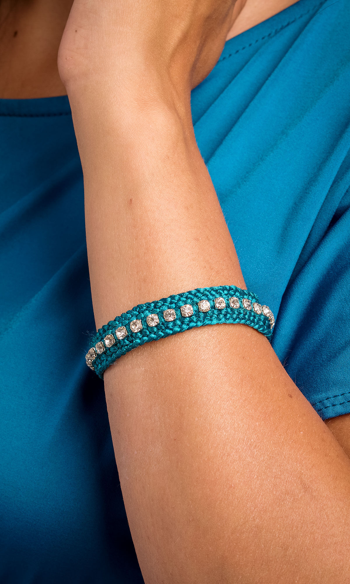 close up shot of model wearing Design Idea R C 3 F Kumihimo 12-Strand Braid with Cupchain