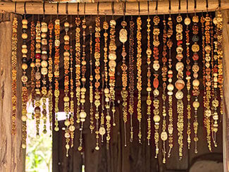 Handmade beaded curtain hanging in a rustic doorway