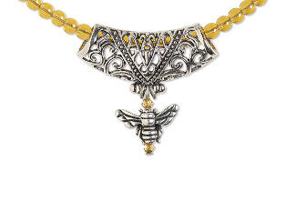 Design Idea R E 3 J - Necklace of golden round glass beads has a wide central pendant of an intricate curved silver trapezoid. A bee charm hangs below the center of the pendant.
