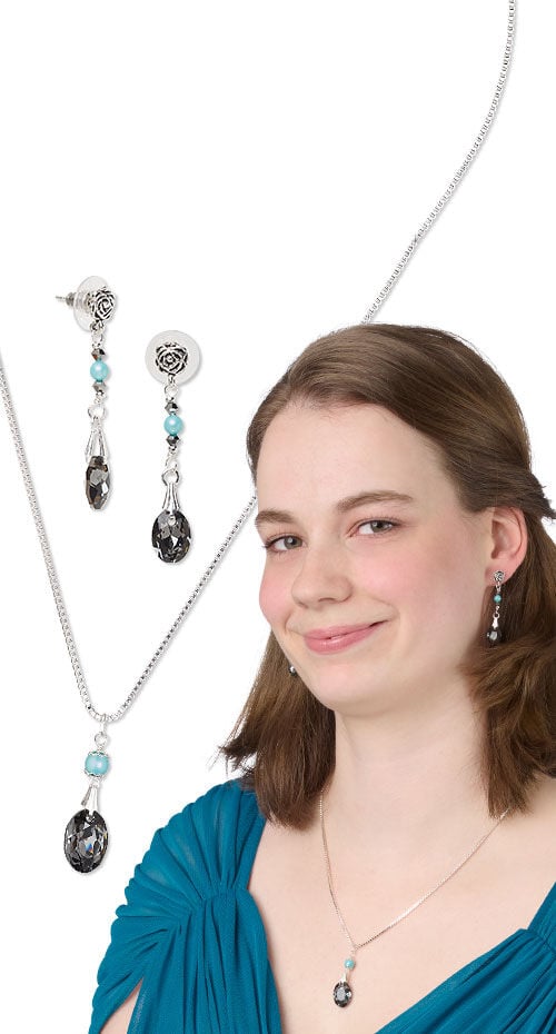 Model wearing necklace and earrings made with crystal passions pendants
