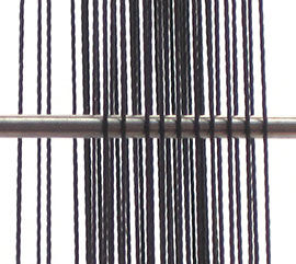 Step 29 - Spring bar woven between warps close up
