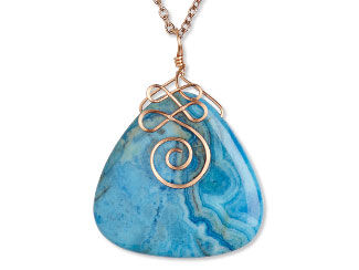 An image of a triangle shaped crazy lace agate focal