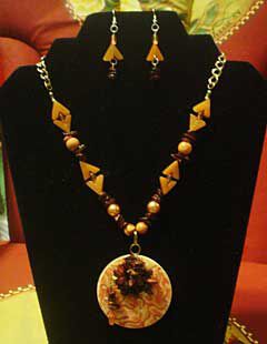 Necklace and earrings on a black display