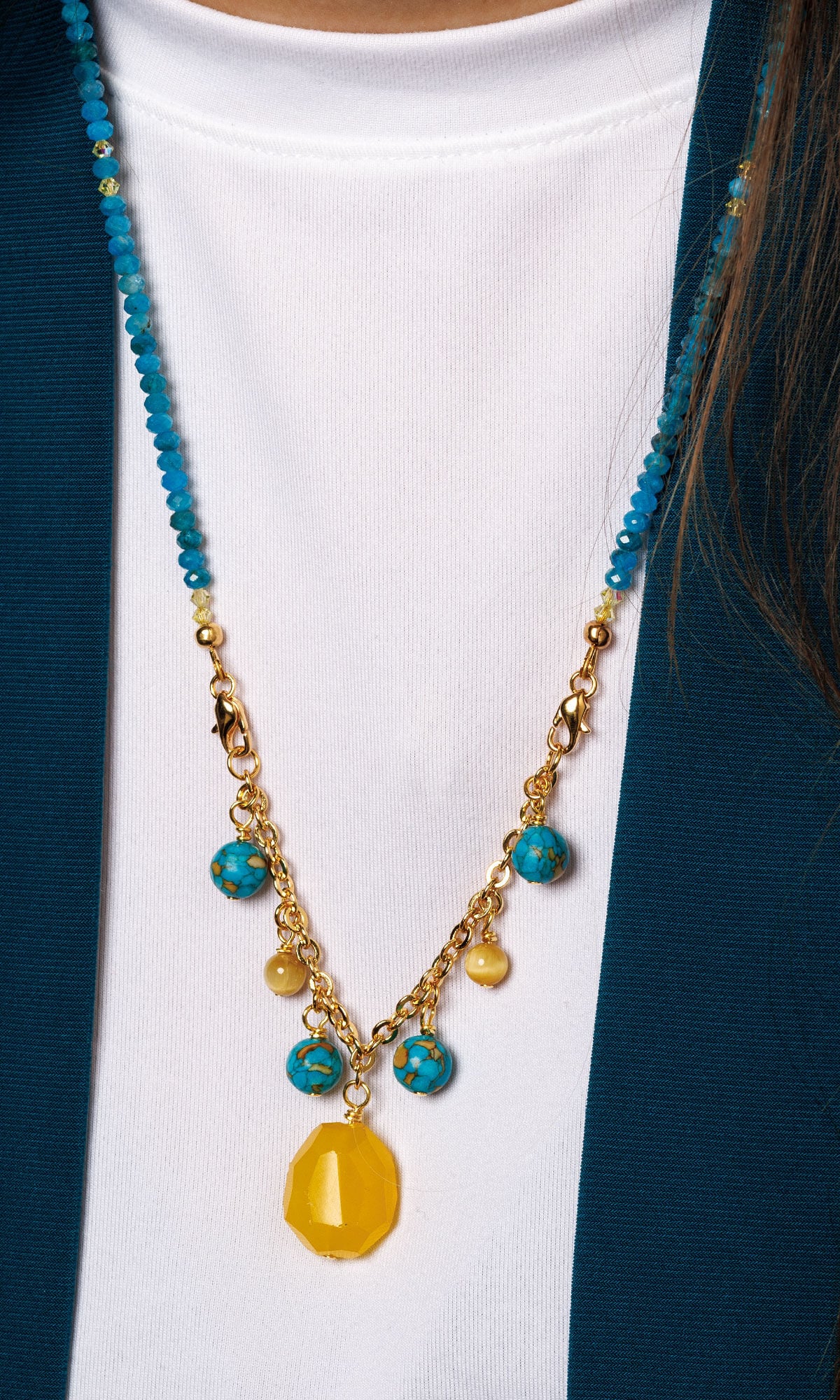 Modeled with Design Idea S F 2 7 - A necklace featuring natural blue apatite faceted rondelle beads, Crystal Passions&reg; light topaz and blue zircon rondelle beads, and a blue zircon Crystal Passions&reg; pendant accented with gold-finished chain and findings.