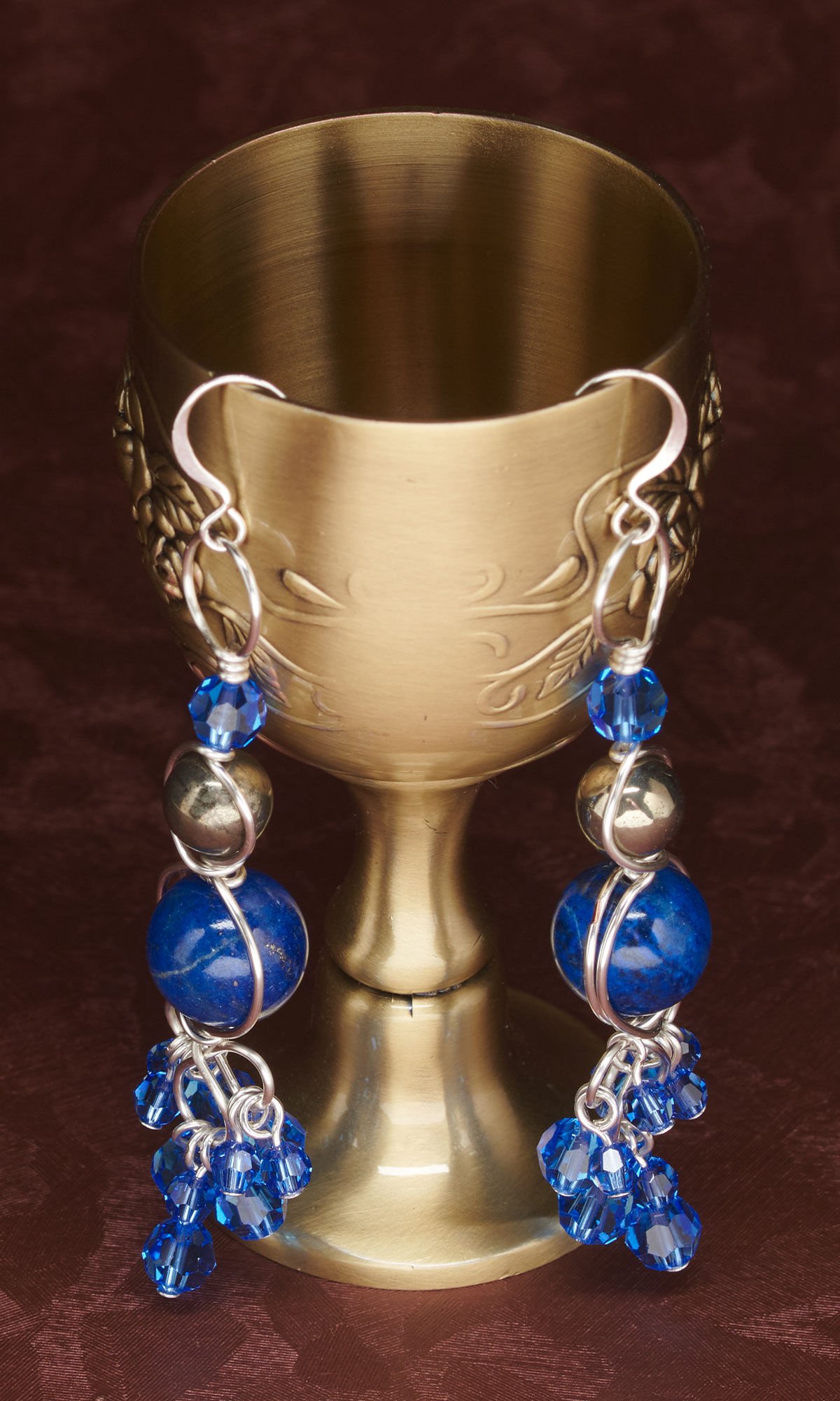 Design Idea R J 2 K - Wireworked earrings featuring graduated sizes of blue and black gemstones and Crystal Passions&reg; blue crystals dangle from chalice cup