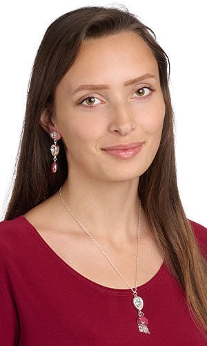 model in a red top wearing Design Idea R N 2 B - Necklace on a silver chain has a pendant of an upside-down teardrop set with clear crystal. The pendant has several strands of chain and a red polymer clay drop hanging beneath it. Earrings have similar pendants, but without the chain.