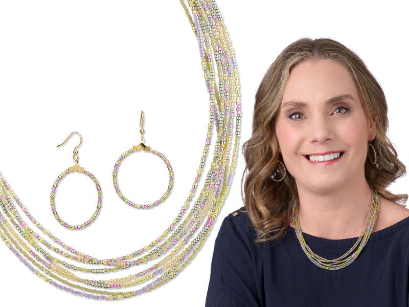 Model wearing a necklace and earrings made with gemstone beads