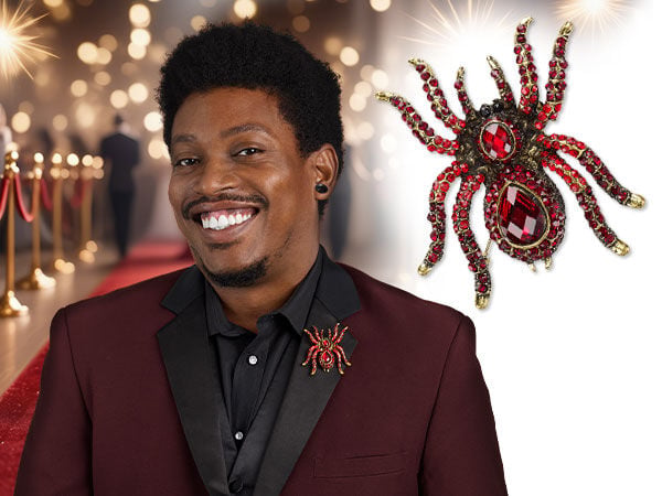 Model with Product 8 6 0 7 J D "spider brooch" pinned to clothes.
