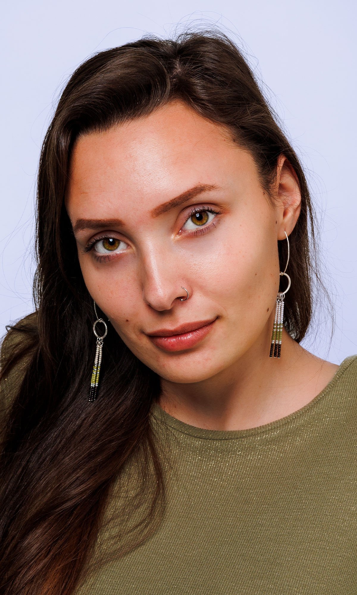 Model wearing design idea S B 2 Z earrings with colors of cactus, iris brown, silver and chalk white