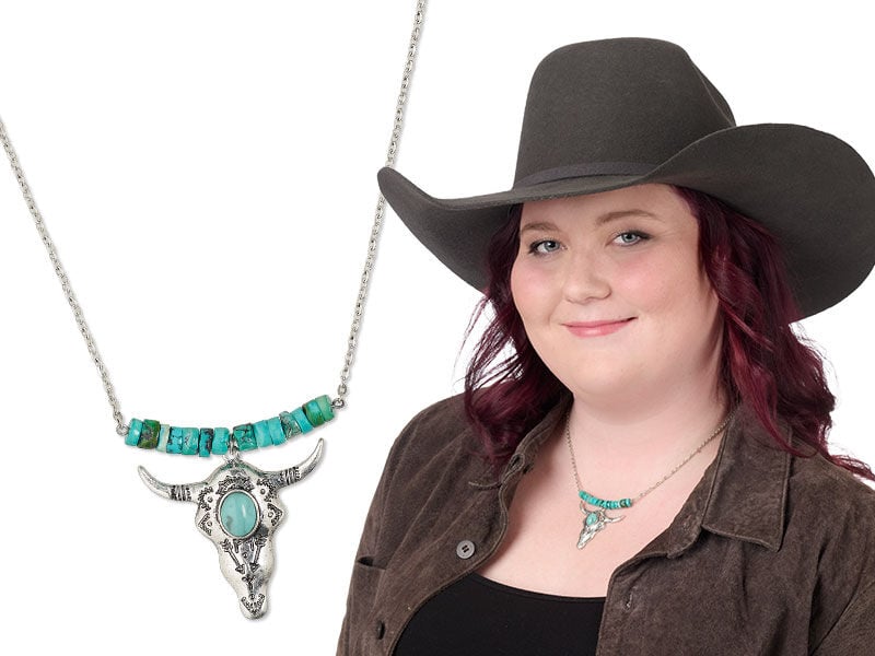 Model wearing a western themed necklace and earrings