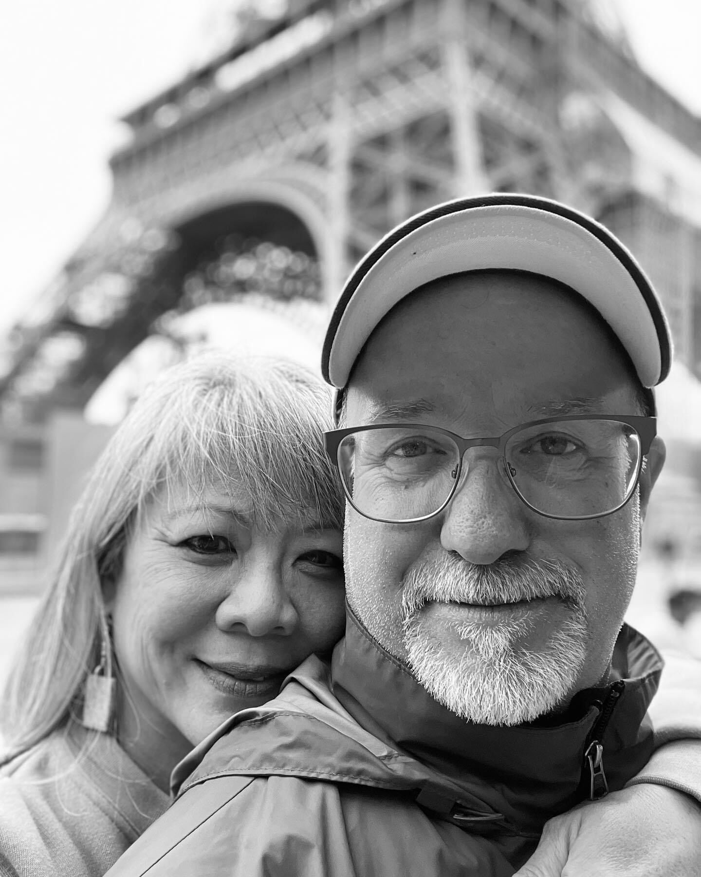 A man and a woman in front of the eiffel tower