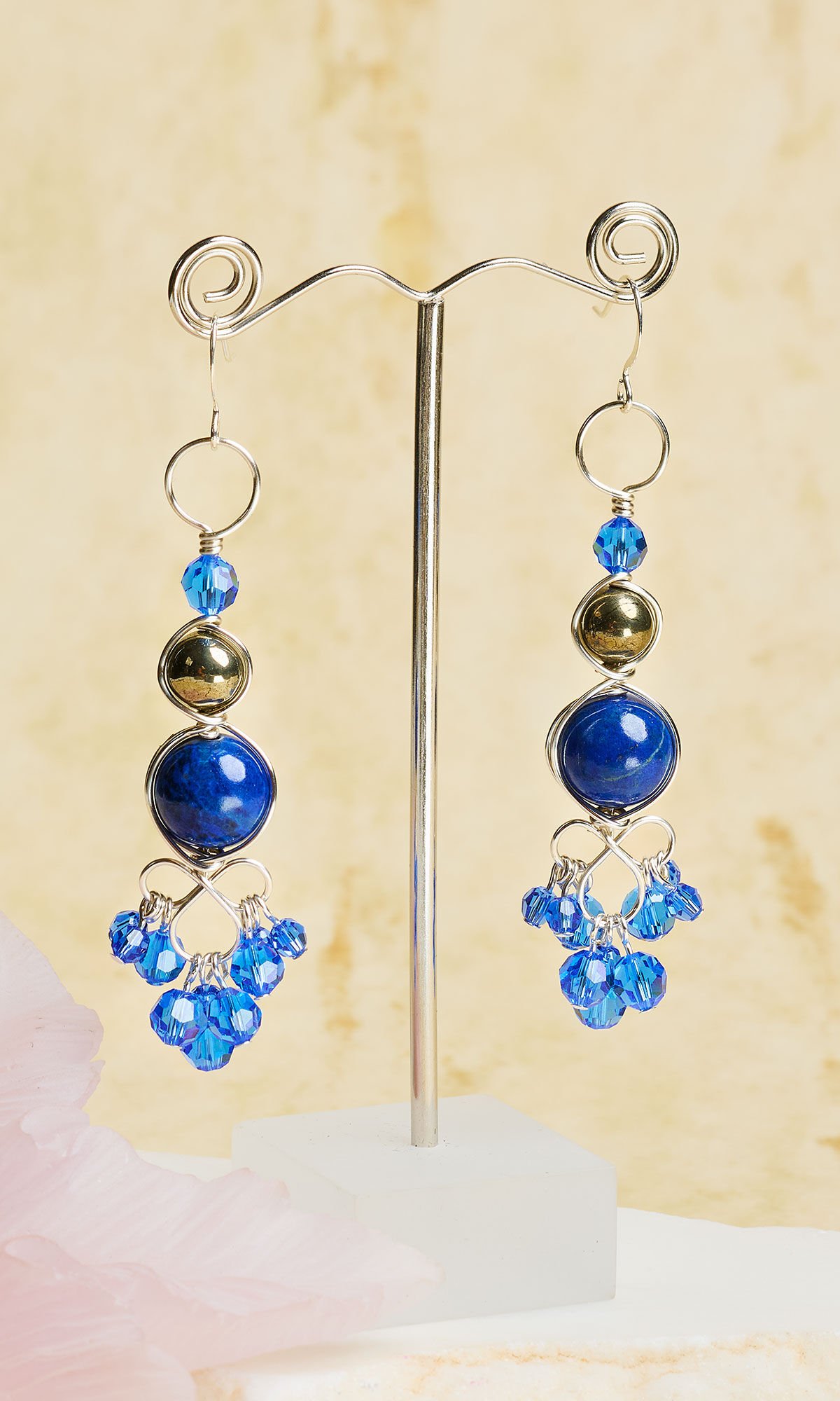 Design Idea R J 2 K - Wireworked earrings featuring graduated sizes of blue and black gemstones and Crystal Passions® blue crystals dangle from silver ear wires.