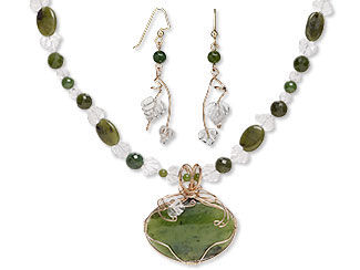 An image of a beaded necklace with a large nephrite jade cabochon as a focal