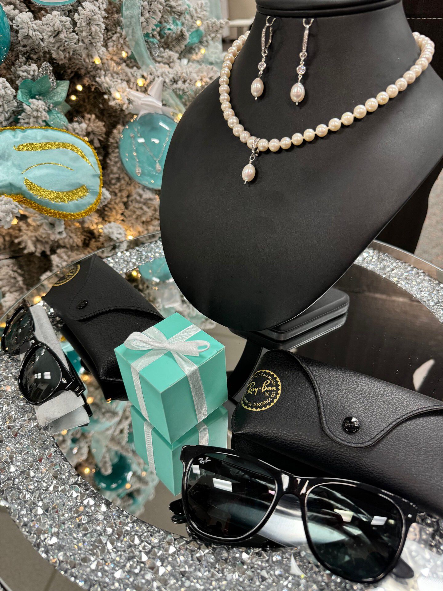 Pearl necklace on a bust surrounded by decorations