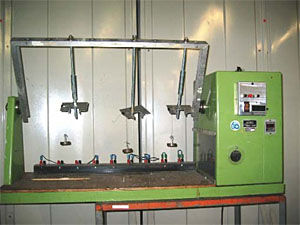 Figure 3: Wire ''Flexing'' machine used for 5,000 flexing operations. Illustration depicts samples as suspended with 1/2lb weight.