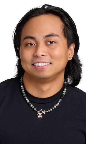 male model in a black t shirt wearing Necklace of glossy grey-toned beads with a silver front clasp in the shape of a Christian fish and a paw print charm.