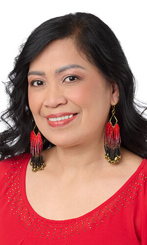 Model wearing Design Idea R K 2 K Earrings have strands of red and black ombr&eacute; style fringe hanging from diamond-shaped gold components and red shirt, facing the left side