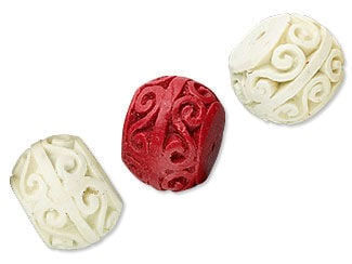 Two white and one red carved cinnabar beads