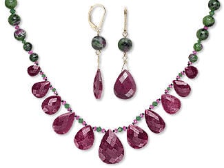 Necklace and earring set featuring ruby teardrops and round green gemstone beads.