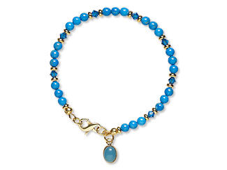 An image of a beaded bracelet with dyed blue howlite beads