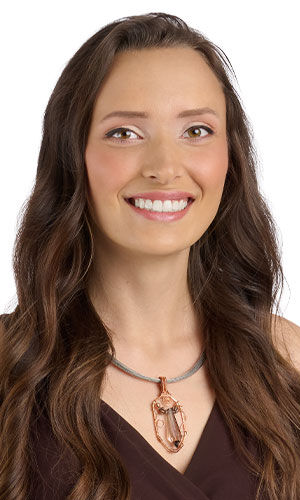 Smiling woman in brown wearing Design Idea R D 2 7