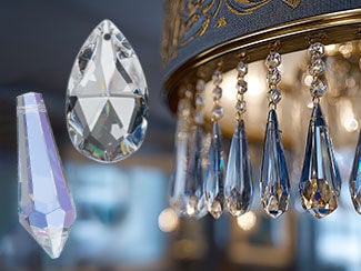 Close-up of a crystal chandelier with a textured gray shade