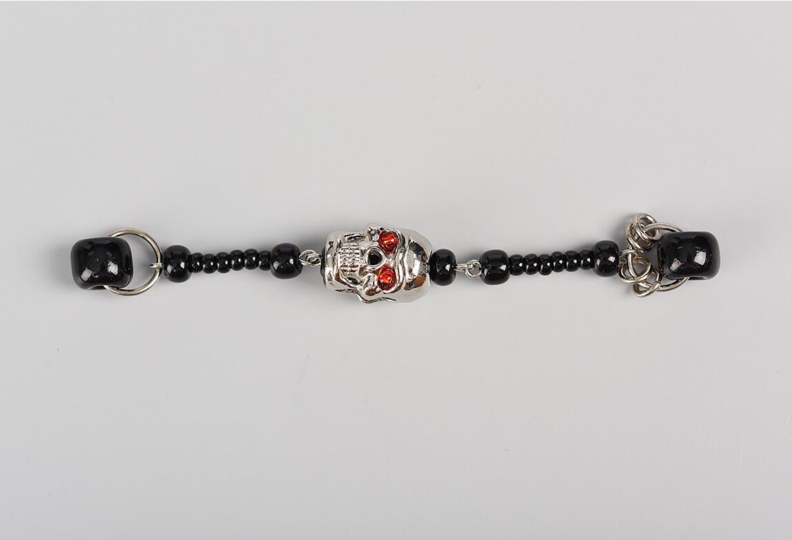 Dangle showing one skull bead with black seed beads on either side of it