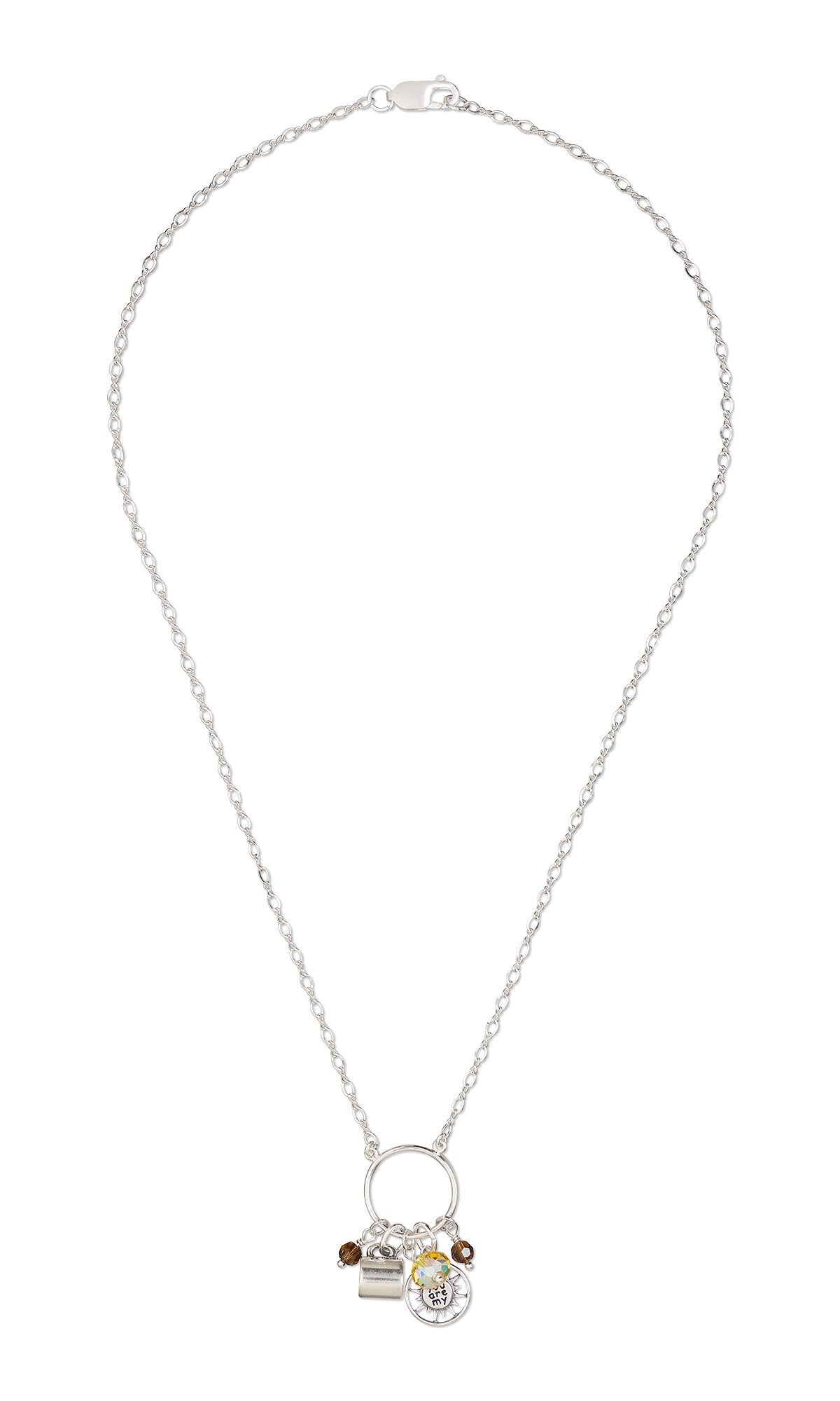 Necklace has a silver circle pendant from which hang drops with brown and yellow crystals and charms in the shapes of a sun and a coffee cup.