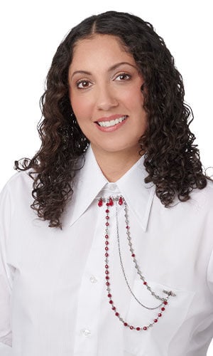 Model with Design Idea R M 2 B attached to the collar and pocket of a white button-down shirt