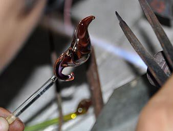 Shaping glass with tongs