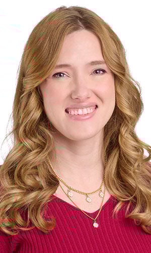 Model wearing magenta blouse modeling two piece necklace set