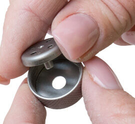 Tube adapter being placed into cap
