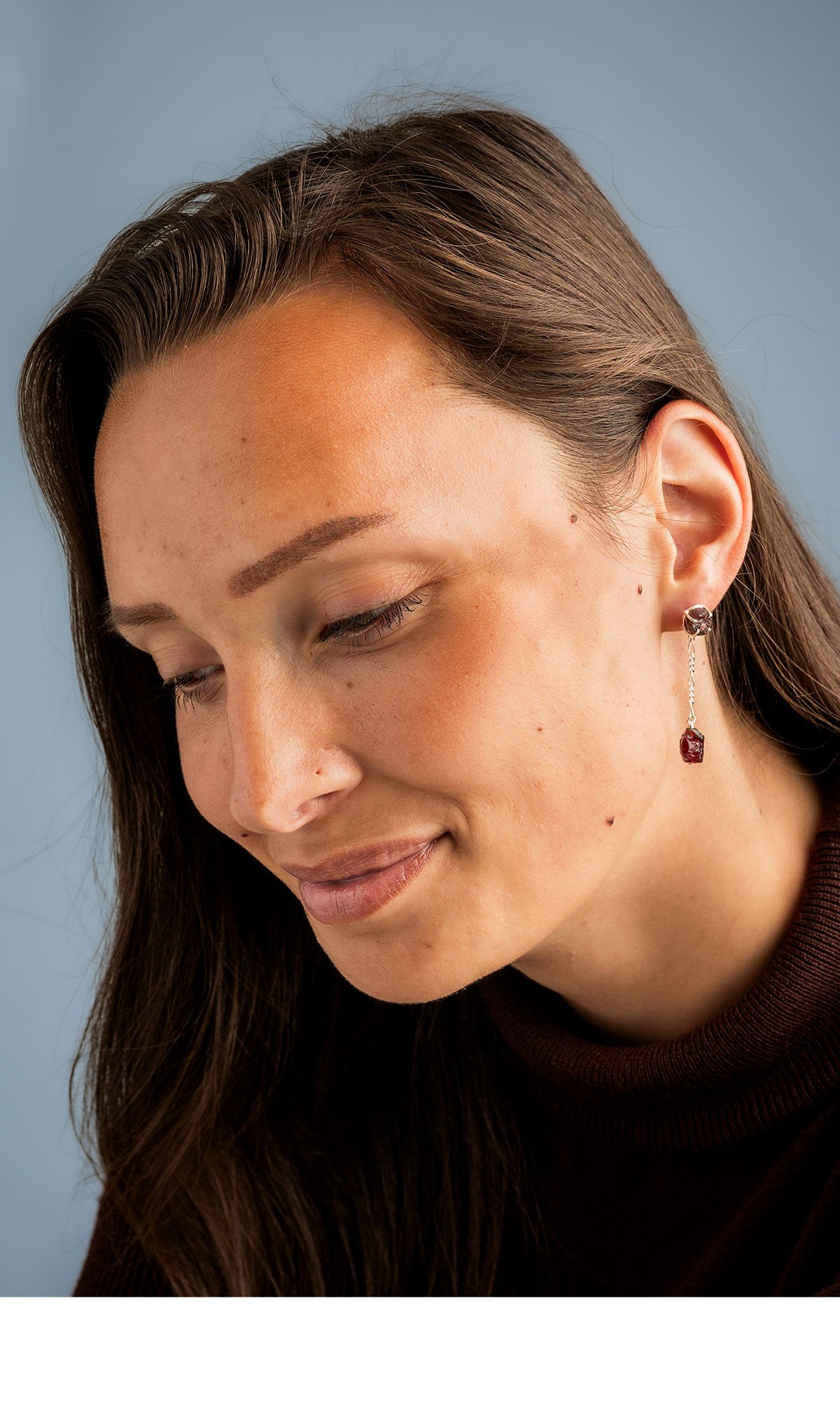 model wearing Design Idea S A 2 2 Garnet nugget stud earrings with another garnet nugget suspended from delicate chain