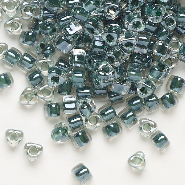 Seed bead, Miyuki, glass, transparent clear color-lined steel blue, (TR1127), #5 triangle. Sold per 250-gram pkg. image number 0